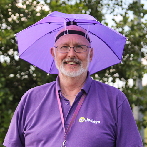 Staff member wearing umbrella hat